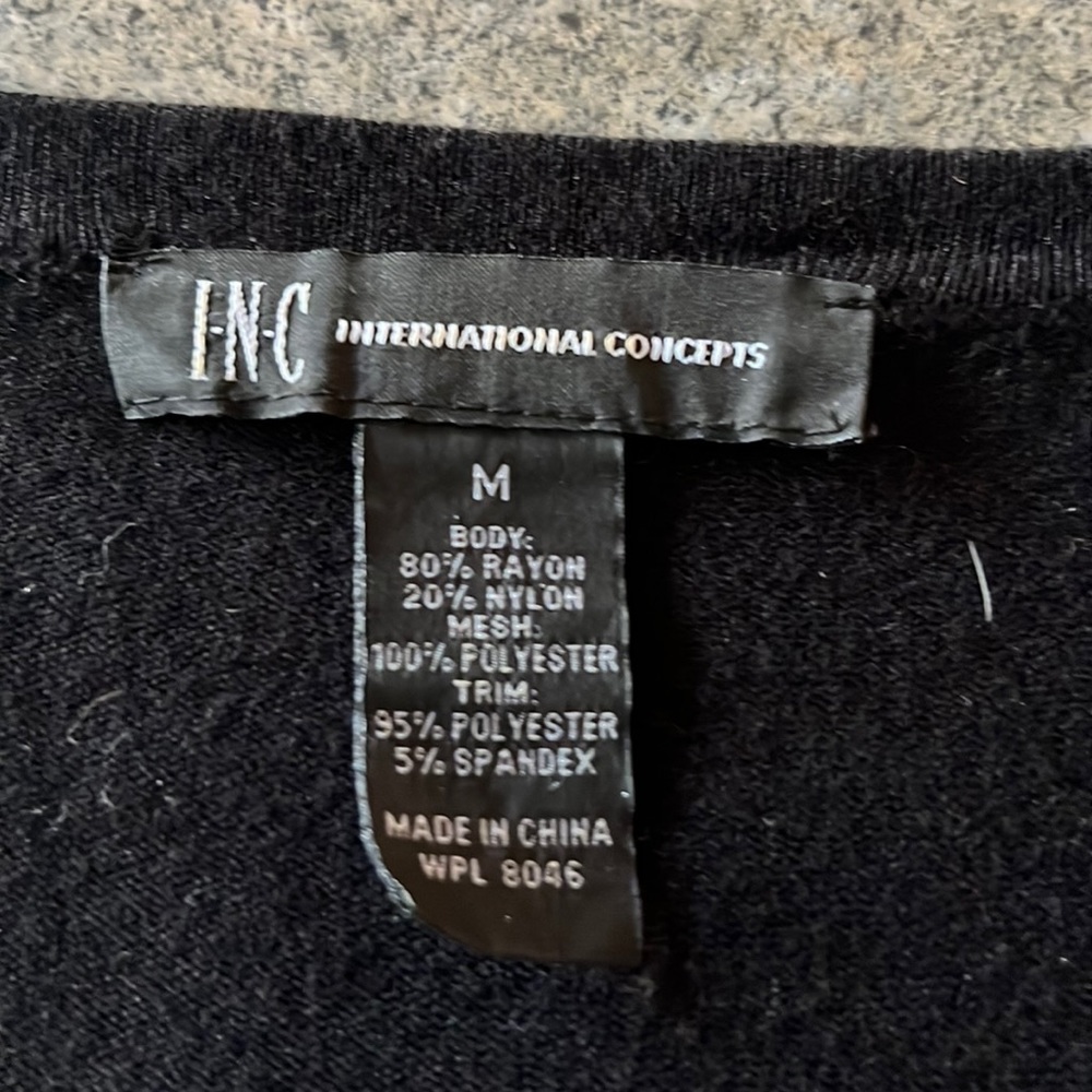 Black sweater with lacey long sleeves. Beautiful to wear over leggings.